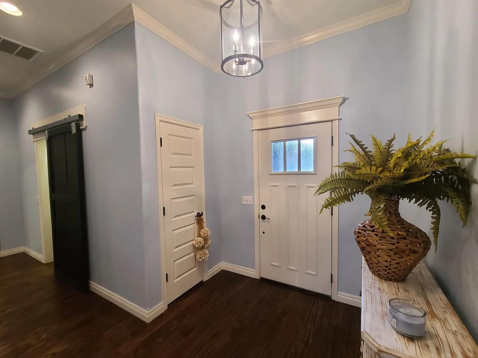 Entryway painted light blue with white trim in a Yukon, OK home